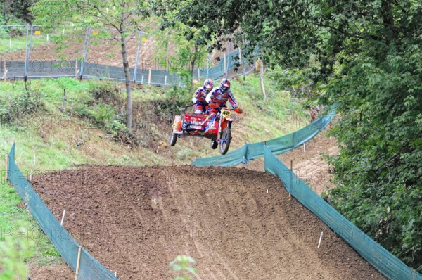 Motocross, Rudersberg, Baden-Württemberg, Germany, Europe, Two riders on a motorbike jump over a hill in a motocross competition, Rudersberg motocross
