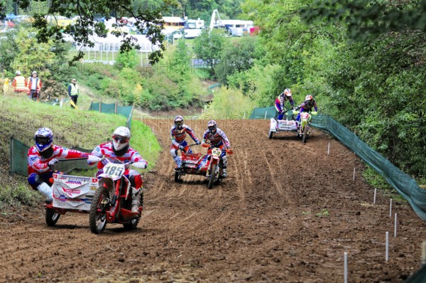 Motocross, Rudersberg, Baden-Württemberg, Germany, Europe, Several sidecar motorbikes in a race on a muddy track surrounded by a wooded area, Rudersberg Motocross