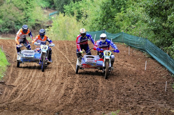 Motocross, Rudersberg, Baden-Württemberg, Germany, Europe, Two sidecar motorbikes in close competition on a winding race track in the forest, Rudersberg Motocross