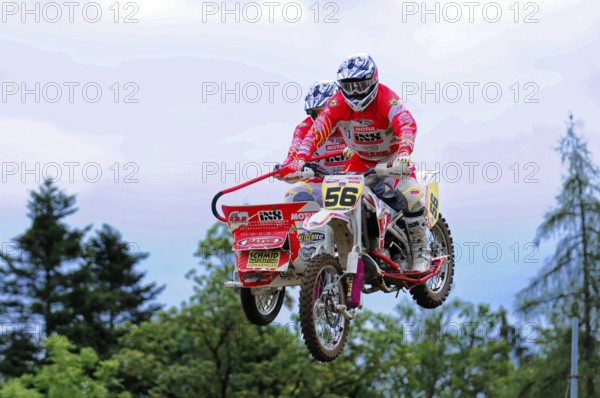 Motocross, Rudersberg, Baden-Württemberg, Germany, Europe, Motorcyclists in red suits during a jump over an outdoor race track, Rudersberg Motocross