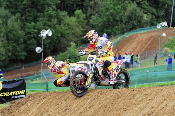Motocross, Rudersberg, Baden-Württemberg, Germany, Europe, Motorbike with two riders in full speed through a curve at a motocross race, Rudersberg motocross