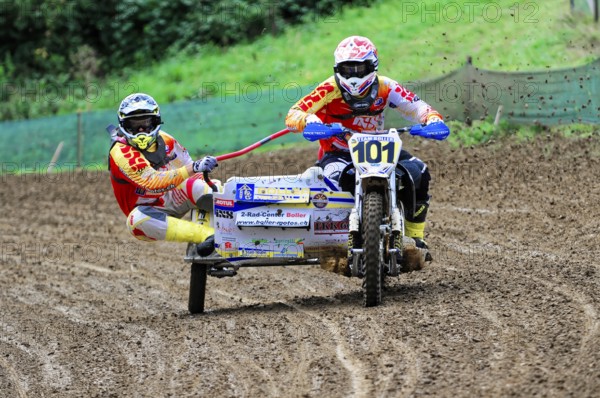 Motocross, Rudersberg, Baden-Württemberg, Germany, Europe, Rider with sidecar races through muddy track, Mud splashes in the air, Rudersberg motocross