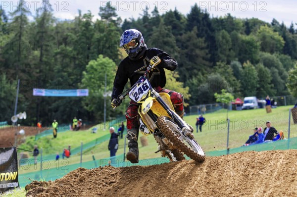 Motocross, Rudersberg, Baden-Württemberg, Germany, Europe, Rider on motorbike in fast ride on earth, surrounded by trees and spectators, Rudersberg Motocross
