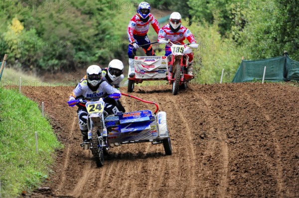 Motocross, Rudersberg, Baden-Württemberg, Germany, Europe, Two sidecar motorbikes ride close together on a muddy track in the forest, Rudersberg motocross