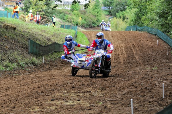 Motocross, Rudersberg, Baden-Württemberg, Germany, Europe, sidecar motorbike on a curvy track surrounded by forest with other riders in the background, Rudersberg motocross