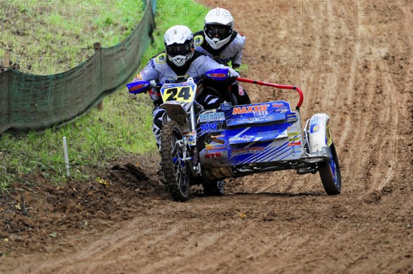 Motocross, Rudersberg, Baden-Württemberg, Germany, Europe, Racing team in action during a tight turn on a muddy track, Rudersberg motocross