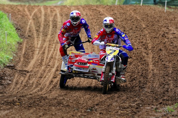 Motocross, Rudersberg, Baden-Württemberg, Germany, Europe, Two riders navigate a sidecar motorbike through a muddy bend on a race track, Rudersberg motocross