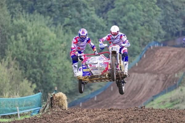 Motocross, Rudersberg, Baden-Württemberg, Germany, Europe, Two motocross riders with sidecars jump into the air on a muddy track, Rudersberg motocross