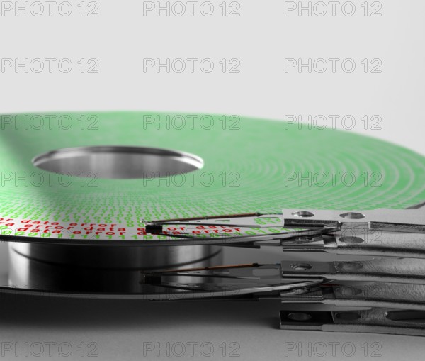 Detail shot of a hard disk platter with actuator arm and symbolic data error processing