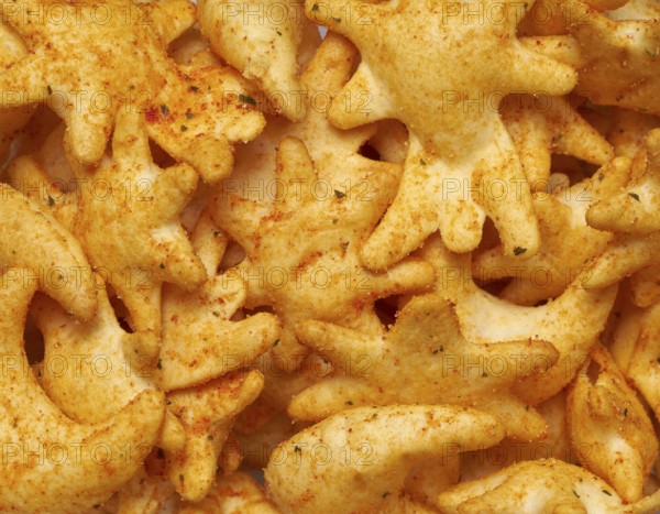 Full frame closeupof some baked crisp salty snack pieces