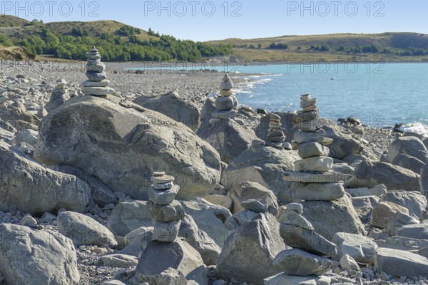 Coastal scenery with stone piles seen around Lake Pukaki at the South Island of New Zealand