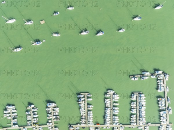 Sports and fishing boats at the marina of the fishing village of Sancti Petri. In the marshland of the Bahía de Cádiz Nature Reserve. Aerial view.. Drone shot. Cádiz province, Andalusia, Spain