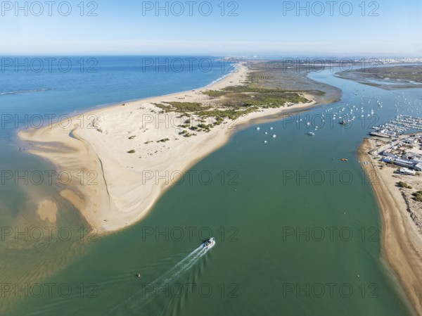 The large sandbar of Punta del Boquerón and partial view of the fishing village of Sancti Petri. In the distance top right the town of San Fernando. Aerial view. Drone shot. Bahía de Cádiz Nature Reserve. Cádiz province, Andalusia, Spain