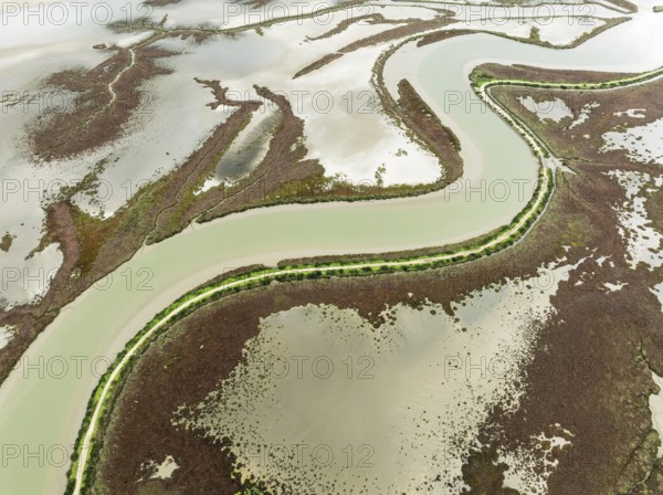 The Barbate river and surrounding marshland at low tide. Nature Reserve La Breña y Marismas del Barbate. Aerial view. Drone shot. Cádiz province, Andalusia, Spain