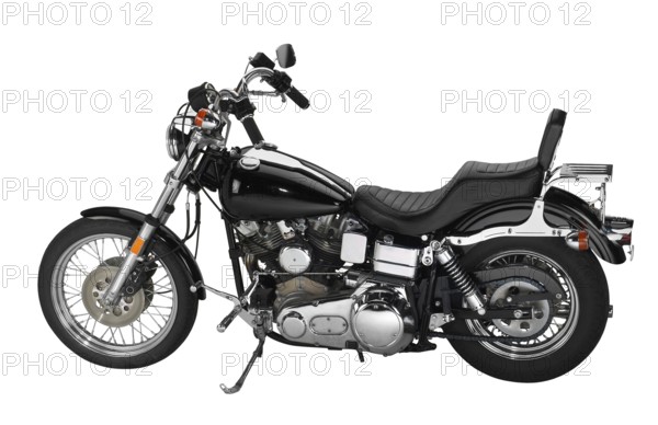 Sideways shot of a vintage motorbike in white back