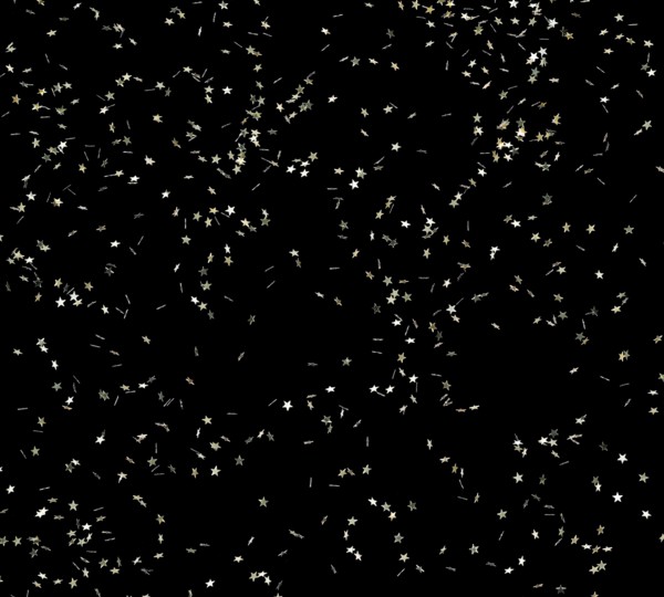 Punched small metallic stars falling in front of black back