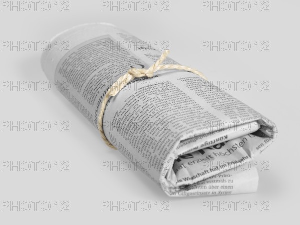 Rolled german newspaper in grey back