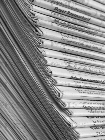 Full frame background with lots of stacked newspapers