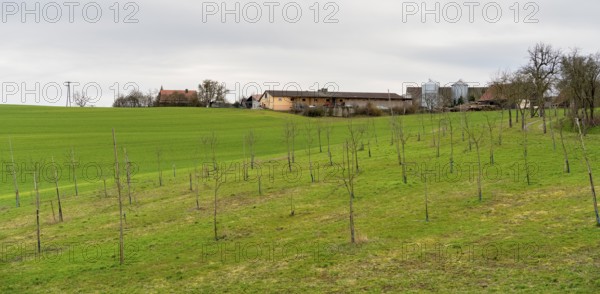 Small rural village with farms and agricultural buildings in Southern Germany at early spring time