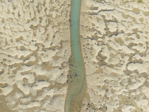 Network of channels and streams at low tide. In the marshland of the Bahía de Cádiz Nature Reserve. Aerial view. Drone shot. Cádiz province, Andalusia, Spain