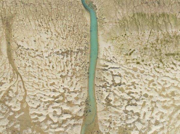 Network of channels and streams at low tide. In the marshland of the Bahía de Cádiz Nature Reserve. Aerial view. Drone shot. Cádiz province, Andalusia, Spain