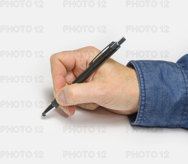 Male hand with ball pen in light back