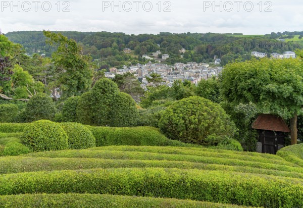 Idyllic garden scenery with green trees, bushes and hedges at summer time seen around Etretat in Normandy, France