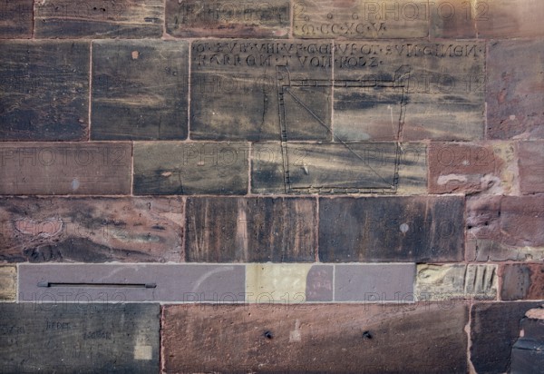 Historic engravings on a stone wall at the Freiburg Minster in Freiburg im Breisgau, a city in southern German