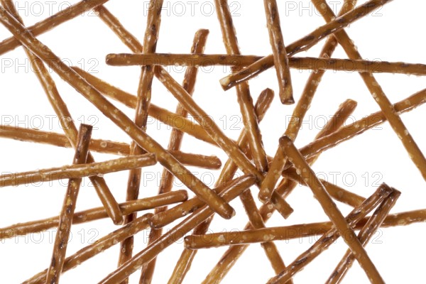 Closeup of some crossed salt sticks in white back