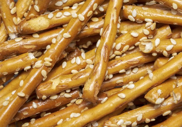 Full frame closeup of some baked sesame sticks