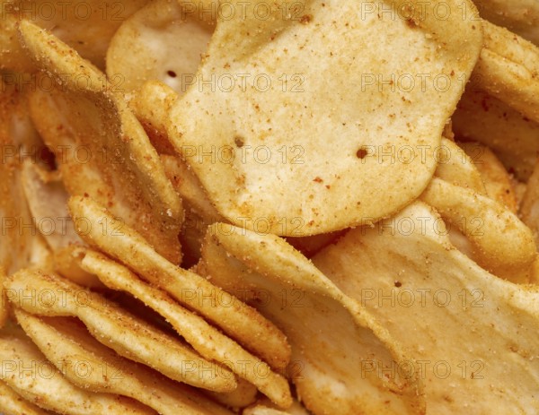 Full frame closeupof some baked crisp salty snack pieces