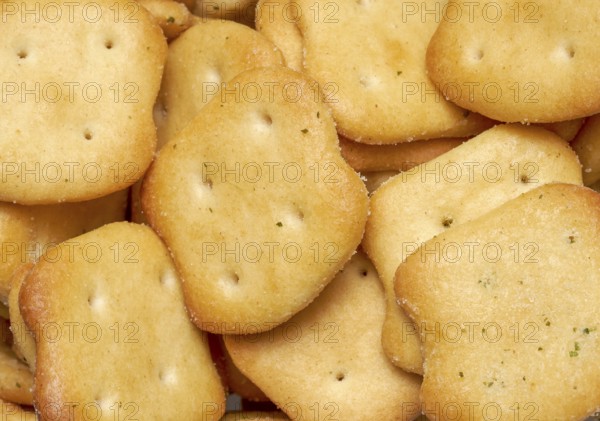 Full frame closeupof some baked crisp salty snack pieces