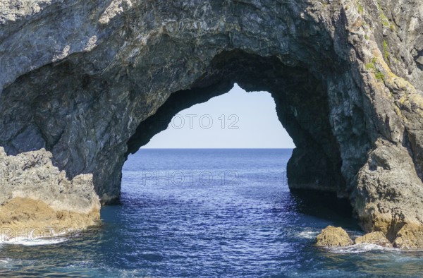 Sunny scenery showing a rock gate at the Bay of Islands, an area on the east coast of the Far North District of the North Island of New Zealand