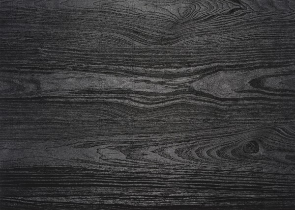 A full frame black wood grain surface