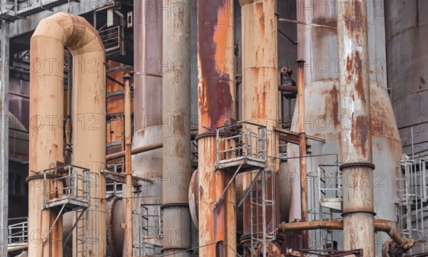 Weathered rusty industrial scenery with old corroded steel girders and metal tubes