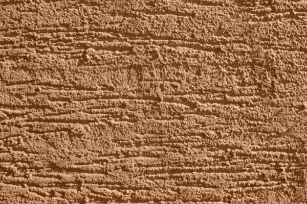 Full frame background showing brown rough plaster