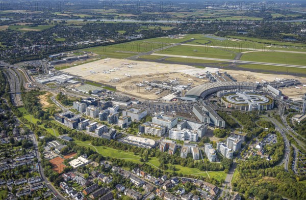 Aerial view, DUS Airport Düsseldorf with terminal building and apron, commercial area DUS Airport-City, Flughafenstraße, Lohausen, Düsseldorf, Ruhr area, North Rhine-Westphalia, Germany, terminal building, DE, reception building, Europe, flight emission, airport, aircraft noise, airfield, runway, aerial photograph, aerial photography, aerial photography, runway, overview, bird's-eye view, bird's-eye view, overview