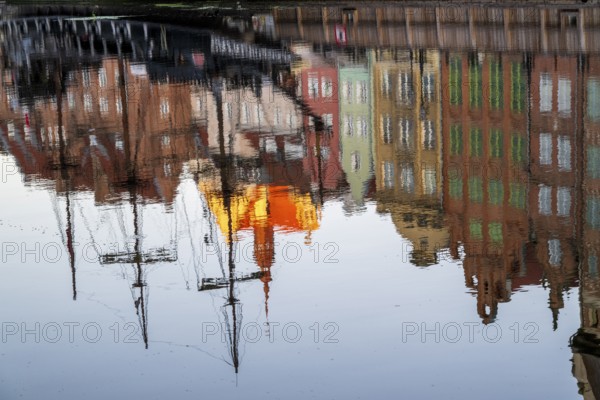Waterfront promenade with reflection at sunrise in the Old Town, Motlawa River, Gdansk, Gdansk, Poland