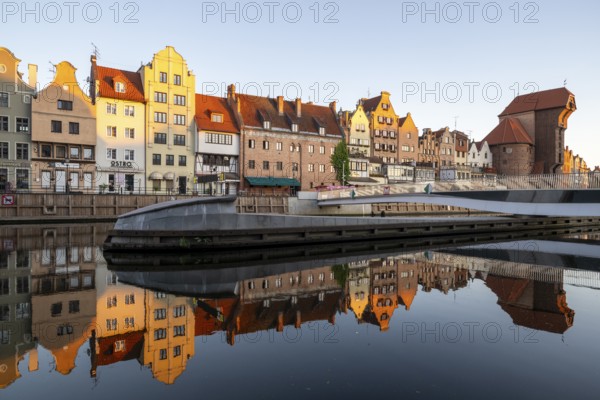 Waterfront promenade with reflection at sunrise in the Old Town, Motlawa River, Gdansk, Gdansk, Poland