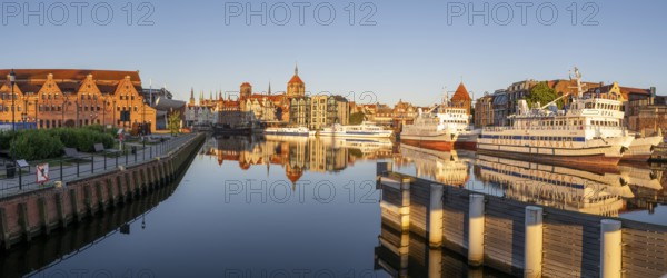 Waterfront promenade with reflection at sunrise in the Old Town, Motlawa River, Gdansk, Gdansk, Poland