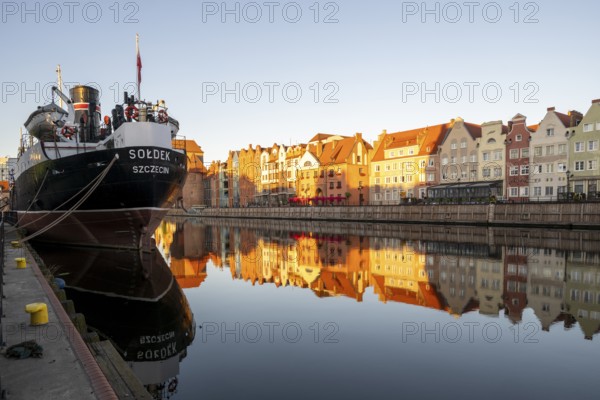 Waterfront promenade with reflection at sunrise in the Old Town, museum ship, Motlawa River, Gdansk, Gdansk, Poland