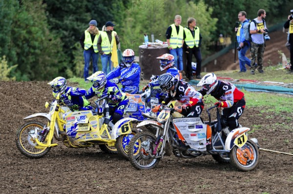 Motocross, Rudersberg, Baden-Württemberg, Germany, Europe, Several motocross riders in colourful gear prepare for the start of a race, Rudersberg motocross