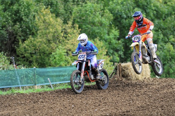 Motocross, Rudersberg, Baden-Württemberg, Germany, Europe, Two motocross riders during a jump over a ramp in a rural area, Rudersberg motocross