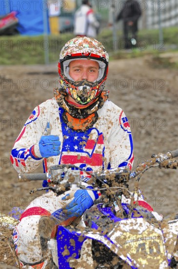 Motocross, Rudersberg, Baden-Württemberg, Germany, Europe, Motocross rider in muddy clothes gives thumbs up, Rudersberg motocross
