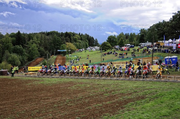 Motocross, Rudersberg, Baden-Württemberg, Germany, Europe, A large group of motocross riders wait for the start of a race on a muddy track, Rudersberg Motocross