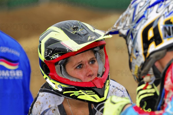 Motocross, Rudersberg, Baden-Württemberg, Germany, Europe, close-up of a woman in a motocross helmet, talking to another rider, Rudersberg motocross