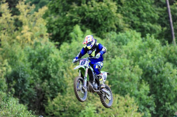 Motocross, Rudersberg, Baden-Württemberg, Germany, Europe, A motocross rider lifts off the ground on his motorbike and flies over a natural track, Rudersberg motocross