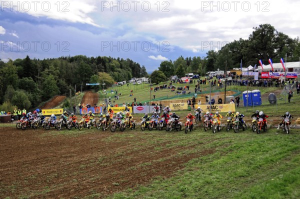 Motocross, Rudersberg, Baden-Württemberg, Germany, Europe, Riders stand side by side at the starting line of a race, with numerous spectators in the background, Rudersberg Motocross