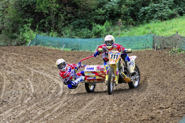 Motocross, Rudersberg, Baden-Württemberg, Germany, Europe, Rider duo with sidecar at high speed through winding, muddy track, Rudersberg motocross