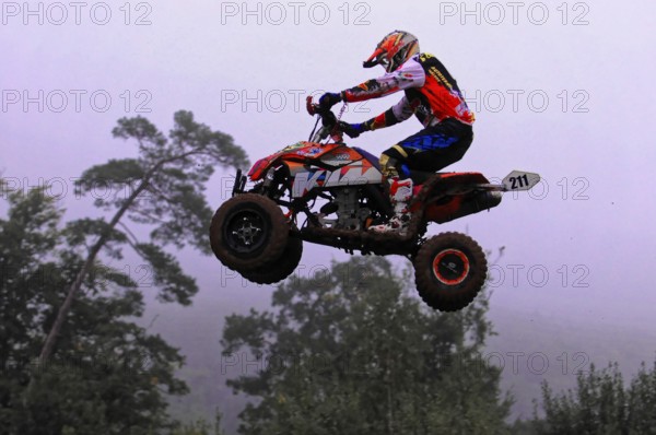 Motocross, Rudersberg, Baden-Württemberg, Germany, Europe, Motocross quad flies through the air, surrounded by trees, Rudersberg motocross